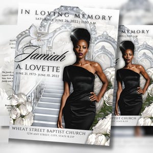 以下が含まれることがあります： 黒いドレスを着た女性、名前「Jamiah A. Lovette」、日付1973年6月21日～2022年6月10日の追悼のお知らせ。デザインには白いバラ、鳩、建築要素が含まれています。