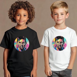 May include: Two children wearing t-shirts with a colorful graphic of a soccer player and the text "I AM MESSI". The t-shirts are black and white.