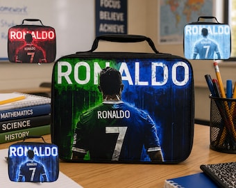 May include: A rectangular black lunch bag featuring a graphic print of a football player seen from the back, wearing a jersey with the number 7 and the name RONALDO. The background has a blue and green gradient effect with the text RONALDO above.