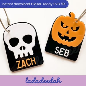 May include: Two Halloween-themed luggage tags. One tag features a white skull on a black background with the name "ZACH" in orange. The other tag has an orange jack-o'-lantern on a black background with the name "SEB" in white. The tags are connected to a silver wire.