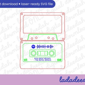 May include: A laser-ready SVG file featuring a cassette tape design. The design includes the text "SUCH GREAT HEIGHTS - THE POSTAL SERVICE" and a Spotify logo with a soundwave. The cassette tape is outlined in red and green.