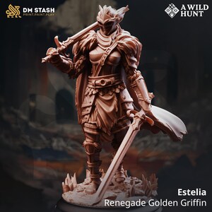 May include: A brown figurine of a warrior, holding two swords, with detailed armour and a cape. The figurine is labelled "Estelia Renegade Golden Griffin" and features the logos "DM STASH PRINT.PAINT.PLAY" and "A WILD HUNT".