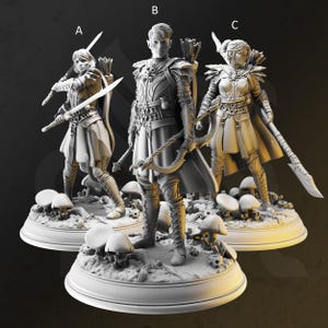 May include: Three miniature figurines of fantasy characters, each standing on a circular base with mushroom-shaped details. The figures are painted in a gray color scheme and appear to be made of a resin-like material. The figures are labeled A, B, and C.