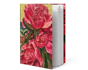 May include: A hardcover notebook featuring a vibrant painting of pink peonies with green leaves against a gold background. The notebook's pages are lined and visible on the right side.