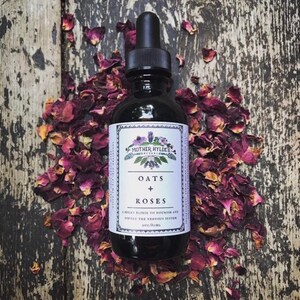 May include: A dark glass bottle with a dropper, labeled "Oats + Roses" surrounded by dried rose petals. The label reads "Mother Hyldes Herbal" and "A milky elixir to nourish and soften the nervous system". The bottle contains 2 oz / 60 ml.