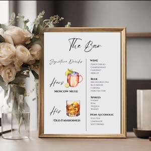 May include: A printable sign for a wedding or party bar with the text "The Bar" and "Signature Drinks". The sign lists a variety of alcoholic and non-alcoholic beverages, including wine, beer, spirits, and non-alcoholic options. The sign also features illustrations of a Moscow Mule and an Old Fashioned.