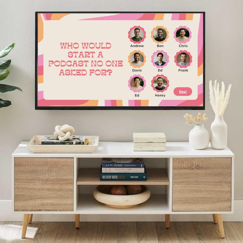 May include: A contemporary TV unit with a screen showing the text "WHO WOULD START A PODCAST NO ONE ASKED FOR?" and headshots. The unit features white and wood-effect cabinets, a decorative tray, books, and vases.