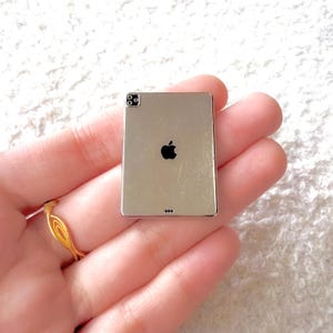 May include: A set of three ceramic mugs with a speckled, matte finish. The mugs are in shades of cream, light gray, and dark gray. Each mug has a simple, minimalist design, perfect for coffee or tea.