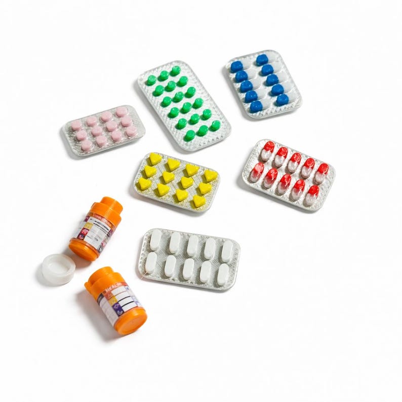 May include: Assortment of colorful pills in blister packs and two orange prescription bottles with white caps. The pills are various shapes and colors, including pink, green, blue, yellow, white, and red.