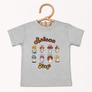May include: A heather grey t-shirt with a graphic of various mushrooms and the text "Autumn Fungi".