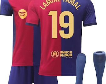 May include: A soccer jersey set featuring a red and blue color-blocked design. The jersey displays the name LAMINE YAMAL and the number 19 in gold, with the UNHCR ACNUR logo below. The shorts are blue with the number 19, and blue socks are included.