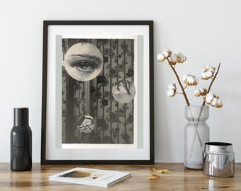 May include: A black and white framed print with a collage of images. The main image is a close-up of an eye. The other images are of a hand and a floral pattern.