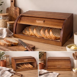 May include: A rectangular wooden bread box with a roll-top lid and a small handle. The interior contains several slices of bread. The exterior features a smooth, medium-brown wood grain finish. The lid slides upward to reveal the contents inside.