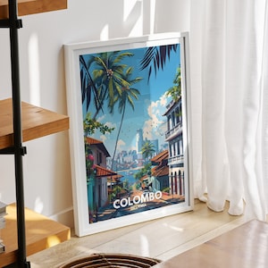 May include: A white framed poster with a colourful illustration of a street scene in Colombo, Sri Lanka. The poster has the word "COLOMBO" printed in white at the bottom.