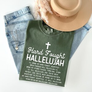 a hat, jeans, and a t - shirt on a white surface