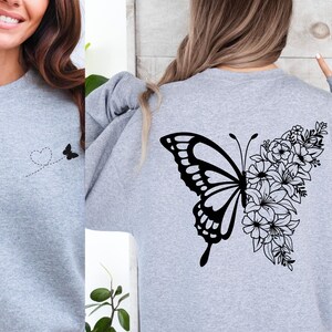 a woman wearing a sweatshirt with a butterfly on it