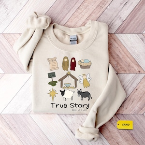 a sweater with a picture of a nativity scene on it