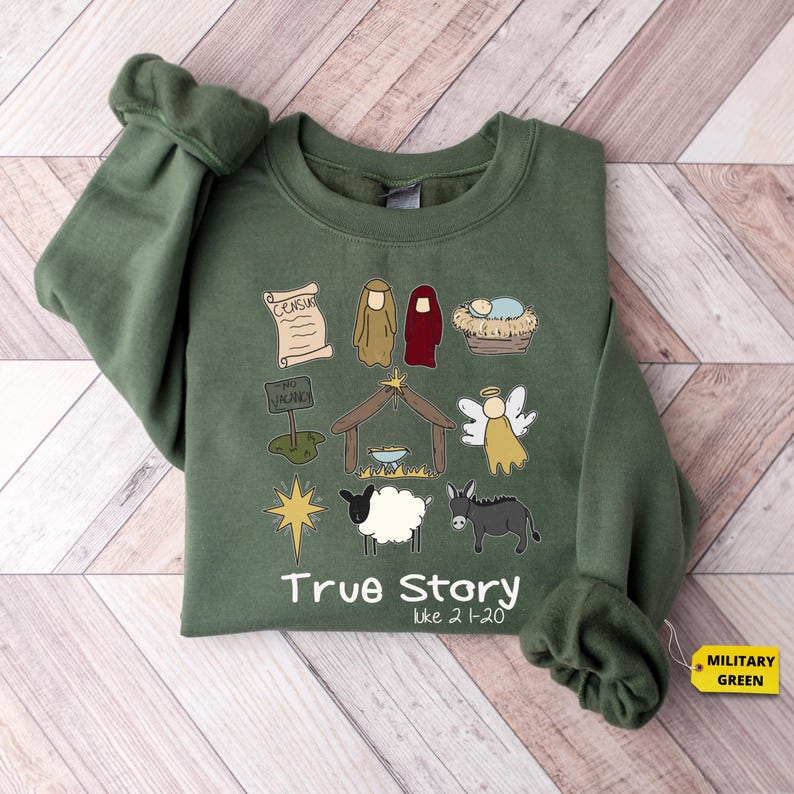 a green shirt with a picture of a nativity scene