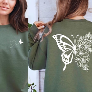 a woman wearing a green shirt with a butterfly on it