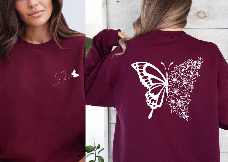 a woman wearing a maroon sweatshirt with a butterfly on it