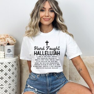 a woman sitting on a couch wearing a white shirt