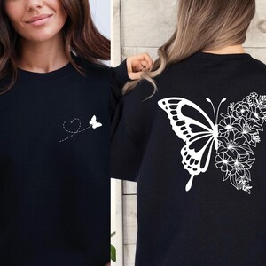 a woman wearing a black shirt with a butterfly on it