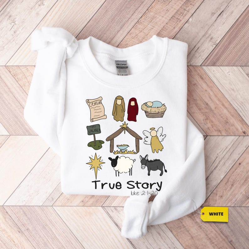a white t - shirt with a nativity scene on it