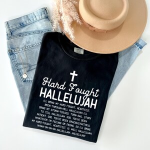 a hat, jeans, and a t - shirt on a white surface