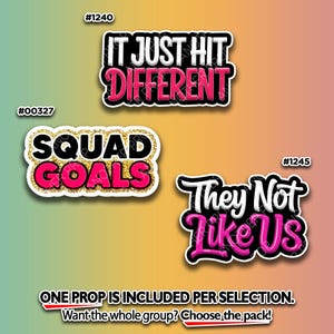 May include: Three sticker props with text. The top sticker says "IT JUST HIT DIFFERENT" in white and pink. The middle sticker says "SQUAD GOALS" in pink and gold. The bottom sticker says "They Not Like Us" in white and pink.