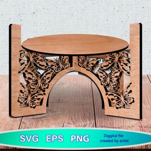 May include: A wooden cake stand with a round top and a decorative butterfly design. The stand is made of wood and has a natural finish.