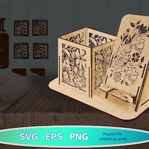 May include: A wooden phone stand and organizer with floral cutouts. The stand has a slot for a phone and a box for storage. The design includes the text "SVG EPS PNG" and "Diggital file created by artist".