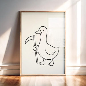 May include: A framed wall art print featuring a simple black line drawing of a duck standing upright and holding a scythe. The illustration is centered on a plain off-white background, enclosed within a light-toned wooden frame.