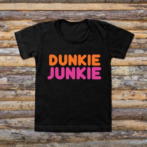 May include: Black t-shirt with the text "Dunkie Junkie" in orange and pink letters.