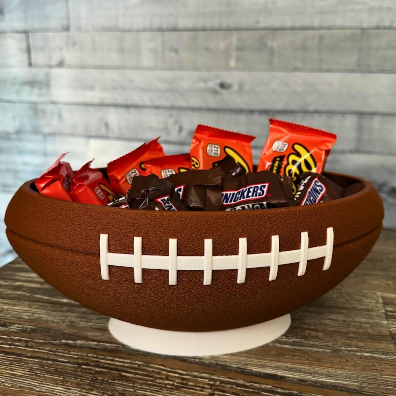 Close up view of 3d printed football snack bowl holding packaged candy.
