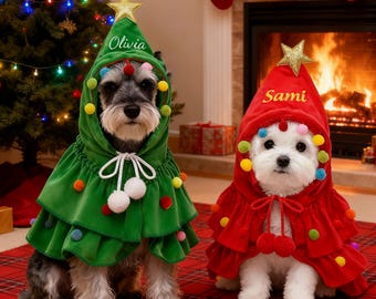 May include: Two dogs wearing Christmas tree-themed outfits. One dog is in a green outfit with the name "Olivia" on the hat, and the other is in a red outfit with the name "Sami" on the hat. Both outfits have colorful pom-poms.