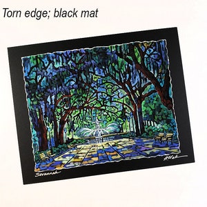 May include: A colorful painting of a park scene with a fountain, benches, and trees. The artwork is set on a black mat with a torn edge. The word "Savannah" is written at the bottom.
