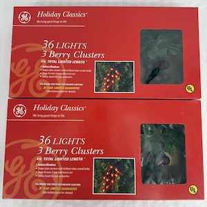 May include: Two red boxes of Holiday Classics 36 Lights 3 Berry Clusters. Each box has a picture of the lights and the text "4 ft. TOTAL LIGHTED LENGTH". The boxes are for indoor/outdoor use and have a 3-year limited guarantee.
