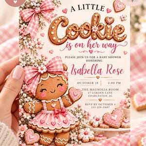 May include: A baby shower invitation card featuring a gingerbread character wearing a pink gingham bow and dress, surrounded by white flowers and heart-shaped cookies. The text reads: A LITTLE Cookie is on her way, honoring Isabella Rose, October 18.
