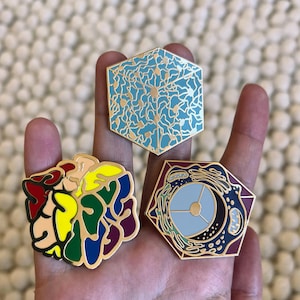 A set of 3 neuro enamel pins