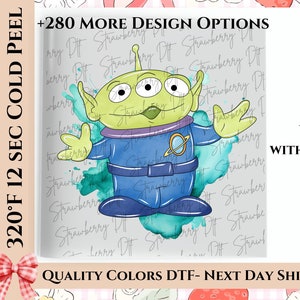 May include: A cartoon alien character with three eyes, green skin, and a blue uniform. The image includes the text "+280 MORE DESIGN OPTIONS" and "WILL BE SENT WITHOUT WATERMARK". The background has a strawberry pattern.