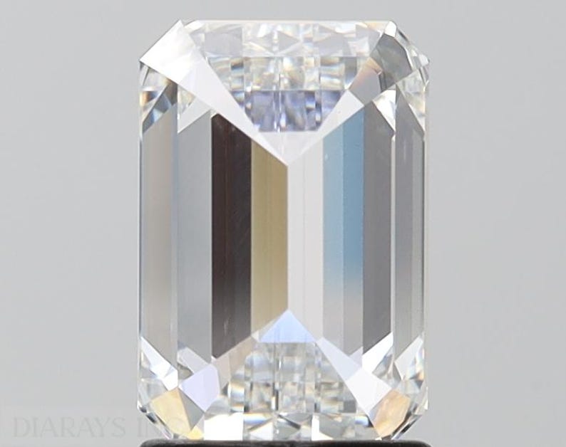 May include: A clear emerald cut diamond with a brilliant shine.