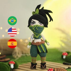 May include: A green and brown crocheted amigurumi doll with black hair in a ponytail. The doll is wearing a green mask and has a serious expression. The doll is standing on a wooden surface with a green background.