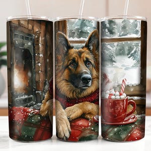 May include: A stainless steel tumbler with a winter scene featuring a German Shepherd dog wearing a red scarf and sitting by a fireplace. The dog is looking at the viewer. The tumbler has a red and green plaid design.