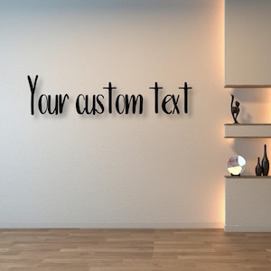 May include: A white wall with the text "Your custom text" written in black. The wall has a built-in shelf unit with a decorative lamp, vases, and a small plant.