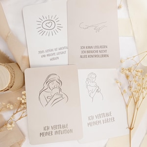 May include: Four rectangular affirmation cards with line art illustrations and German text. The cards feature drawings of a sun with a heart, reaching fingers, a person holding a baby, and a pregnant person, with phrases about intuition and trust.