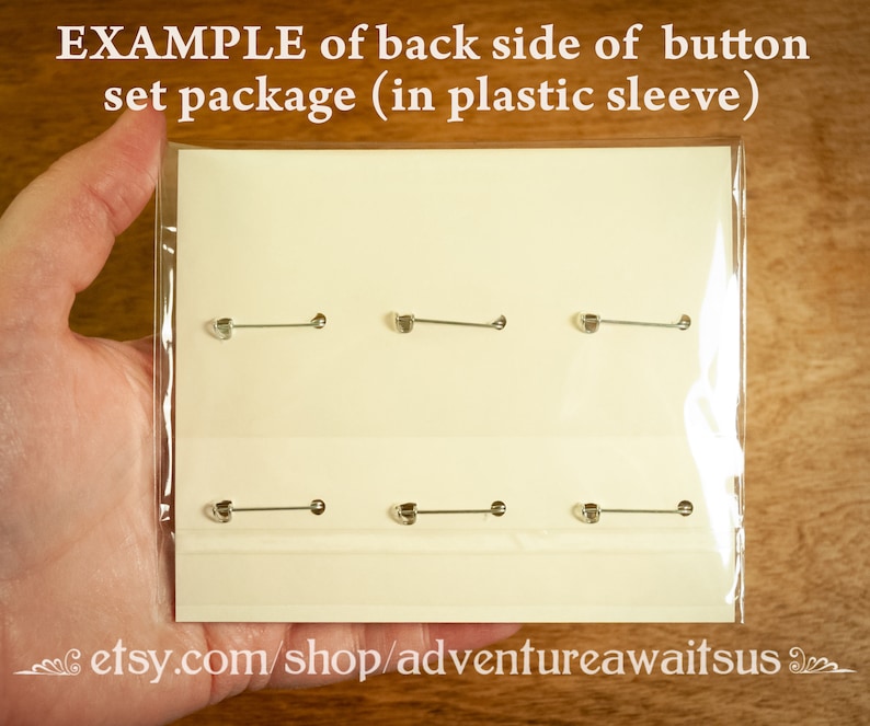 May include: A close-up of a white card with six silver button pins displayed on it. The card is in a clear plastic sleeve. The text "etsy.com/shop/adventureawaitsus" is printed at the bottom of the card.