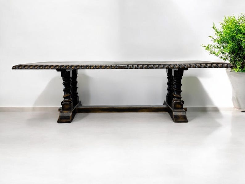 May include: A dark brown wooden dining table with a carved top and twisted legs. The table is standing on a white floor.