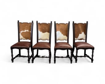 May include: Four dark wood chairs with brown leather seats and cowhide backs. The backs are rectangular with a brown and white pattern. The chairs have dark wood frames and legs, and are arranged in a row against a white background.
