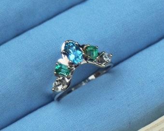 Tropical Spectrum wedding band or engagement ring in 14K white gold with reclaimed emeralds, diamonds and blue topaz
