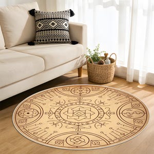 Puede incluir: Una alfombra redonda beige con un diseño geométrico marrón con símbolos y formas. La alfombra tiene un borde blanco y está colocada sobre un suelo de madera. Un sofá beige y un cojín decorativo están en el fondo.